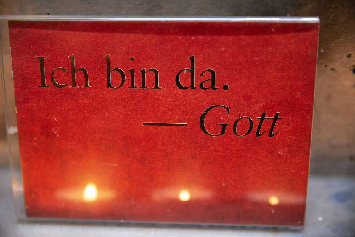 Trostaltar in der Autobahnkapelle Kassel (Autohof Lohfeldener Rüssel) für Angehörige tödlich Verunglückter mit der Aufschrift "Ich bin da - Gott" auf rotem Untergrund.