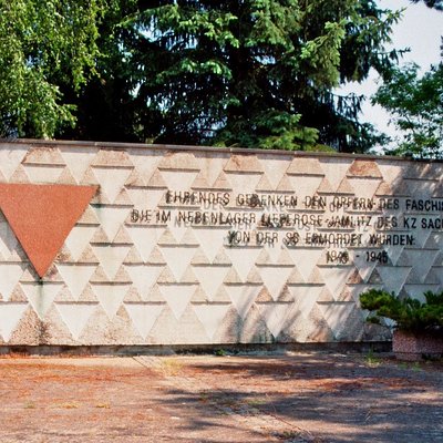 Das Mahnmal gegen Faschismus und Krieg neben dem Friedhof in Lieberose. Die Aufschrift auf der Mauer lautet: Ehrendes Gedenken den Opfern des Faschismus, die im Nebenlager Lieberose-Jamlitz des KZ Sachsenhausen von der SS ermordet wurden. 1943-45. Foto: Wikimedia / JH Janßen